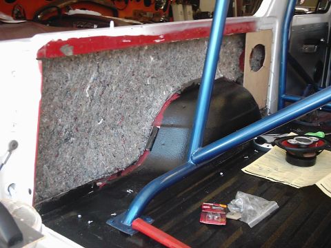 1978 Ford Bronco - Vehicle interior with roll cage installation and sound deadening material visible.
