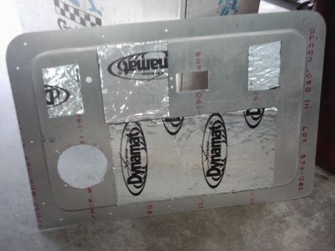 1978 Ford Bronco - A metal panel is covered in Dynamat sound deadening material, with several cutouts for various components.