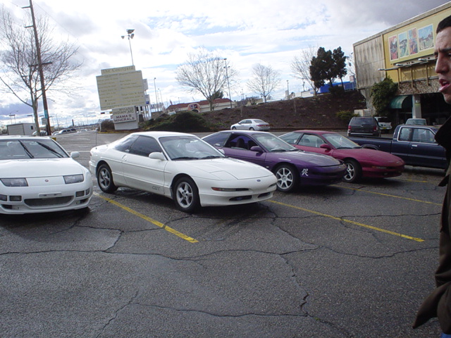 White 1993 Ford Probe parked in a lot, showing its front 3/4 view and side profile