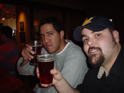 1993 Ford Probe - Two friends are enjoying drinks at a bar, with one man wearing a baseball cap.