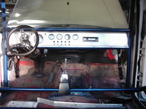 1978 Ford Bronco - The interior of a 1978 Ford Bronco features a roll cage, custom dashboard with multiple gauges, and an aftermarket steering wheel.