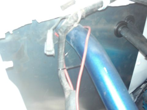 1978 Ford Bronco - Close-up view of wiring and a blue tube within a vehicle's engine bay.