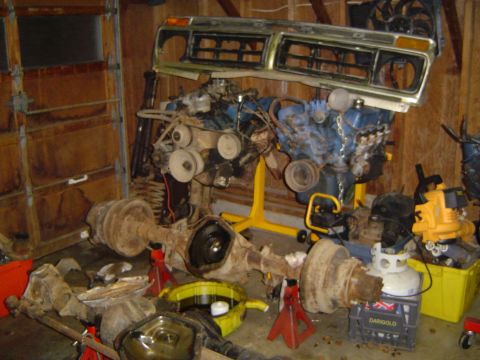 1989 Ford Bronco - Engine and axles are disassembled and stored in a garage.