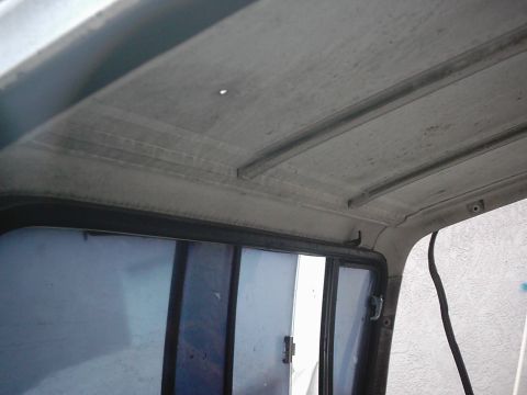 1978 Ford Bronco - Close-up of the interior ceiling and window frame of a vehicle, with visible texture and structural elements.
