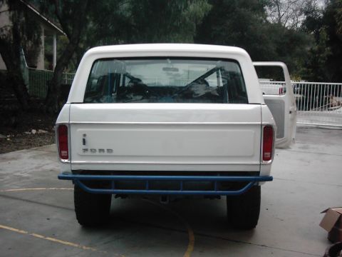 1978 Ford Bronco - This 1978 Ford Bronco is seen from the rear, a blue roll cage and an aftermarket bumper.