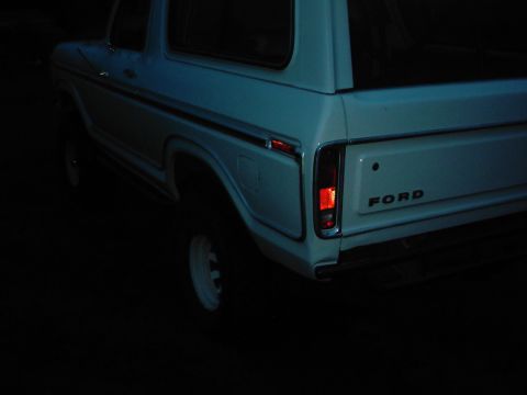 1978 Ford Bronco - Rear view of a white 1978 Ford Bronco, showing the quarter panel and taillight.