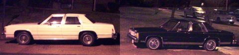 1985 Ford Crown Victoria LTD - Two sedans are parked on a street at night, with one white and one dark colored vehicle visible.