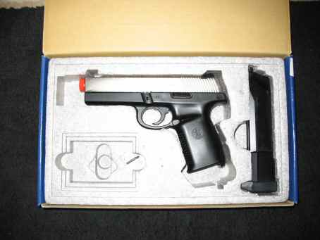 1996 Ford Taurus - A pistol and magazine are packaged in a box with foam inserts.
