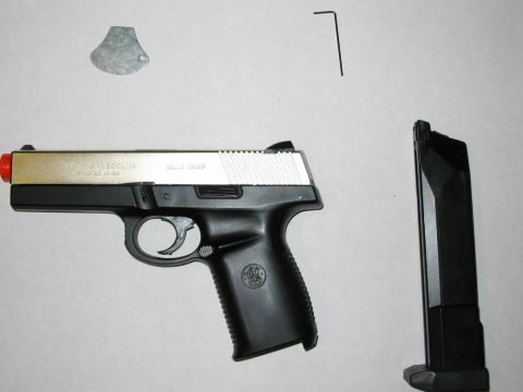 1996 Ford Taurus - A Smith & Wesson pistol is shown with its magazine and included tools.