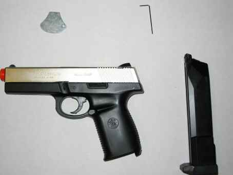 1996 Ford Taurus - Pistol, magazine, and Allen wrench laid out on a flat surface.