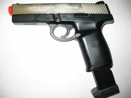 1996 Ford Taurus - This is a Smith & Wesson pistol with a red tip and an extended magazine.