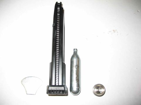 1996 Ford Taurus - Air gun magazine and CO2 cartridge shown against a white background.