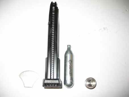 1996 Ford Taurus - A Crosman CO2 cartridge and airgun magazine are displayed against a white background.