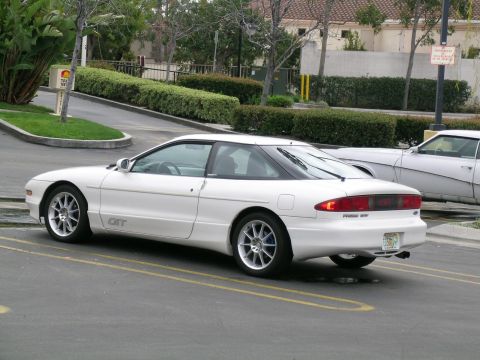 1993 Ford Probe - A white 1993 Ford Probe GT is parked in a lot, seen from the rear three-quarter angle.