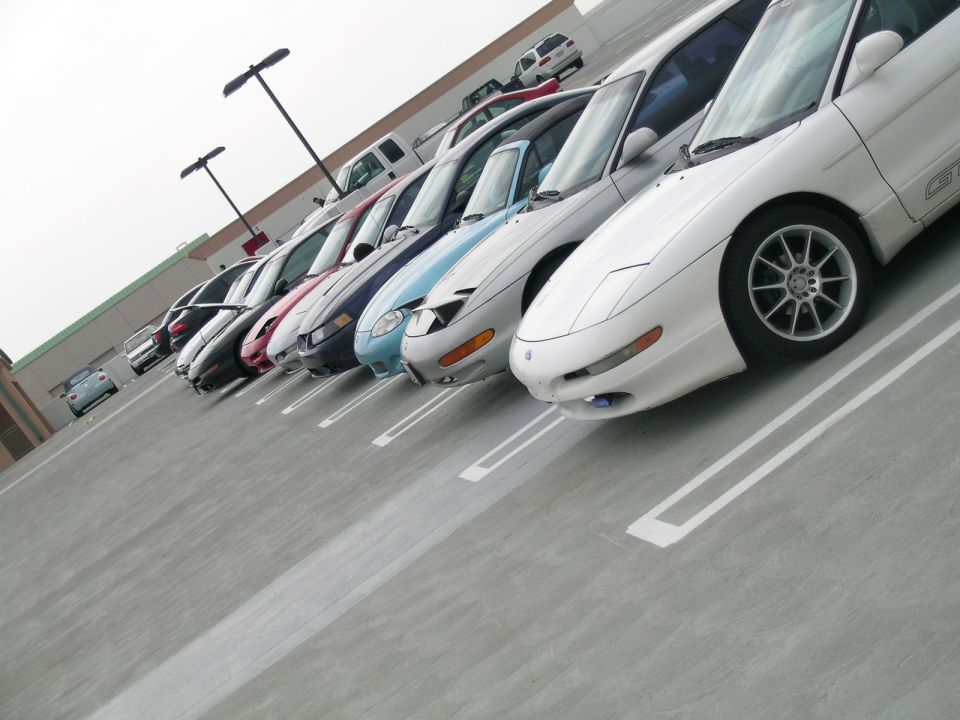 White 1993 Ford Probe in a parking lot, front 3/4 view, showing alloy wheels and 'GT' badging