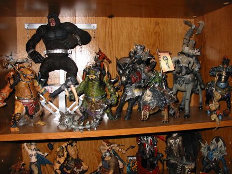 1991 Ford Bronco - A shelf displays a variety of fantasy action figures, including a large ape, monstrous creatures, and armored warriors on horseback.