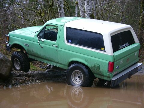 1990 Ford Bronco - This 1990 Ford Bronco navigates a muddy off-road course, its capabilities.
