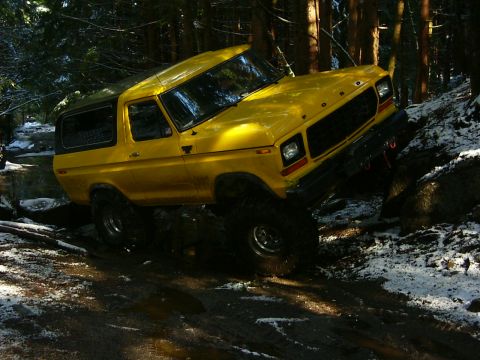 1990 Ford Bronco - This 1978 Ford Bronco navigates a challenging off-road course through a forest.
