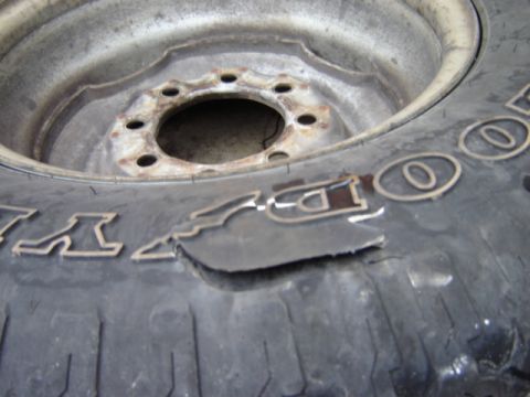 1992 Ford Bronco - Tire shows significant damage to the raised lettering on its sidewall.