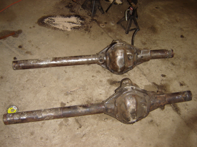 Two differential axles resting on a concrete floor