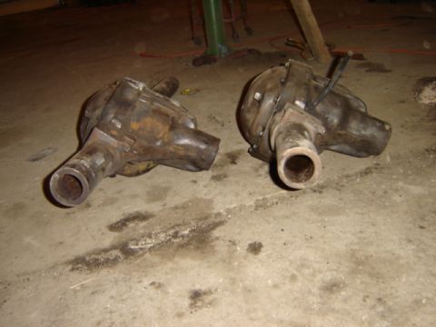 1992 Ford Bronco - Two differential housings are shown resting on a concrete floor, appearing to be parts removed from a vehicle.