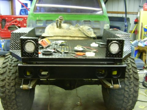 1990 Ford Bronco - Custom truck bed modification in progress, showing tools and parts on the deck.
