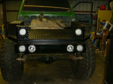 1990 Ford Bronco - Custom truck bed features diamond plate accents and modern LED lighting, obscuring original vehicle details.