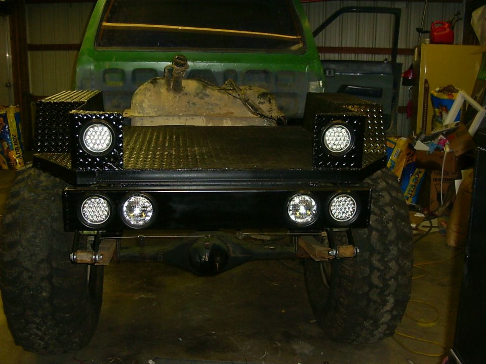 Rear view of green truck bed with diamond plate toolboxes and LED lights