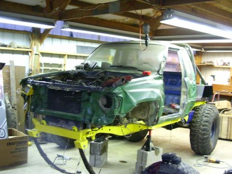 1990 Ford Bronco - This vehicle is in a state of disrepair and modification, with its front end disassembled in a workshop.