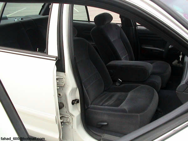 Interior view of a 1999 Mercury Grand Marquis showing front seats and door panel