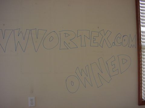 1998 Volkswagen Jetta - Graffiti on a wall reads "VWORTEX.COM OWNED" with a SuperMotors logo in the corner.