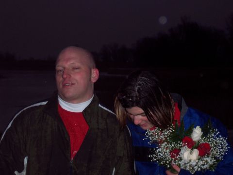 1987 Ford Bronco - Two people pose for a photo at night, holding a bouquet of flowers.