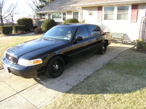 1999 Ford Crown Victoria - 1998 Ford Crown Victoria parked outside a suburban house on a sunny day.