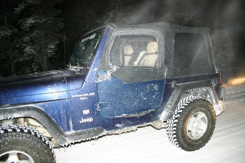 2003 Jeep TJ - A blue 2003 Jeep Wrangler 4.0L is covered in snow and icicles, parked in a snowy environment.