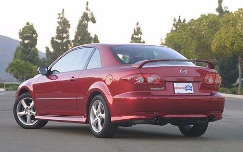 1997 Ford Probe - Rear view of a red Mazda 6 coupe with a spoiler and dual exhaust pipes.