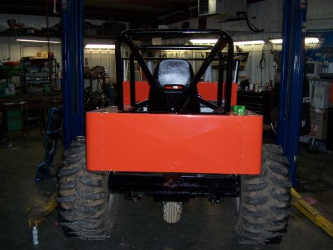 1999 Jeep TJ - This off-road vehicle, possibly modified, is shown from the rear in a workshop setting.