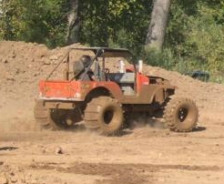 1999 Jeep TJ - This heavily modified Jeep is shown off-road in a muddy environment.