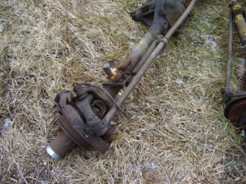 1992 Ford Bronco - Rear axle assembly, likely from a 1992 Ford Bronco, resting on the ground.