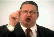 2002 Ford Taurus - A man in a suit gestures emphatically while speaking, with a white background.