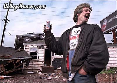 1990 Ford Bronco - A man celebrates with a can as a monster truck rests precariously on the roof of a damaged house.