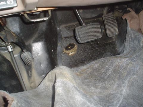 1993 Ford Taurus - The interior footwell shows the pedals and a small nest that has been built in a floor opening.