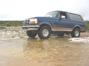 1996 Ford Bronco - This blue 1996 Ford Bronco is captured mid-drive through a watery terrain.
