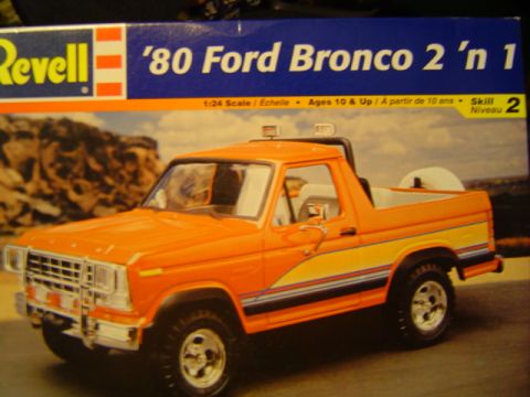 1979 Ford Bronco - Box art for a Revell '80 Ford Bronco 2 'n 1 model kit shows an orange Bronco with yellow and blue racing stripes.