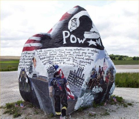 1991 Ford Bronco - This painted rock displays patriotic themes and historical quotes, including a POW-MIA symbol and a quote from John F. Kennedy.