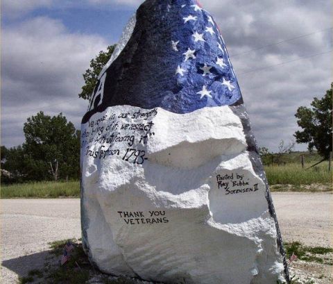 1991 Ford Bronco - A large rock is painted to resemble the American flag and features patriotic messages.