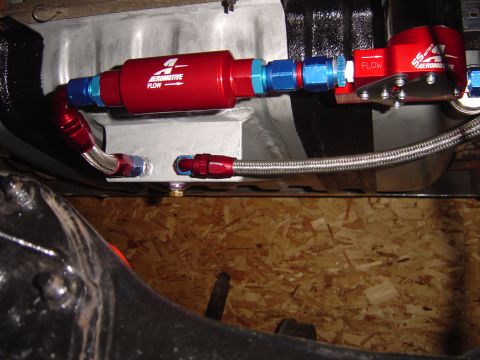 1978 Ford Bronco - Close-up of an aftermarket fuel system component, likely a fuel filter and pump, installed on a vehicle.
