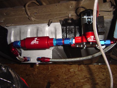 1978 Ford Bronco - Close-up of an aftermarket fuel system component, likely a fuel filter and pump, installed on a vehicle.