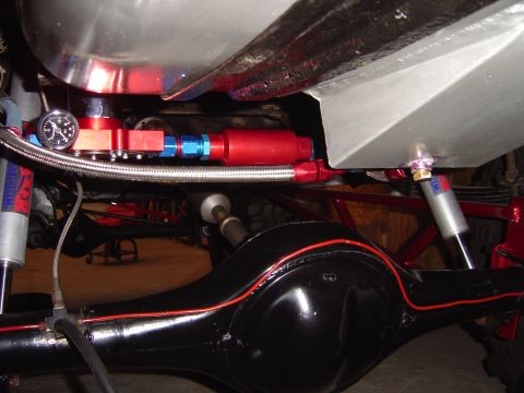 1978 Ford Bronco - Custom fuel system components, including a gauge and filter, are visible on the underside of a vehicle.