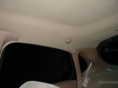 1997 Ford Taurus - Interior shot showing the headliner and window frame of a vehicle.