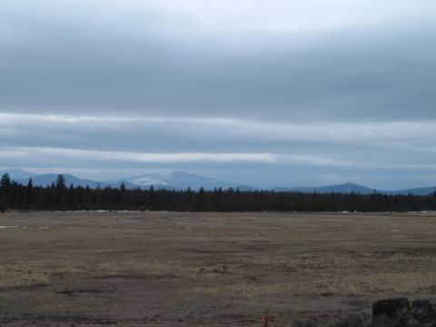 1989 Ford Bronco - Wide landscape scene with mountains in the distance and a field in the foreground.